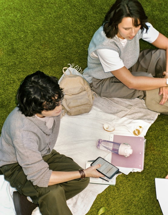 two-people-having-a-picnic-on-the-grass.jpg Two people having a picnic on the grass